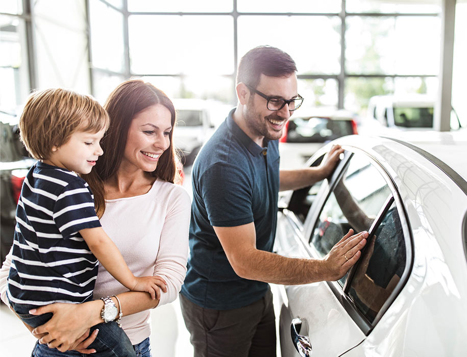 family looking at car